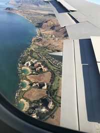 Aerial view of cityscape seen through airplane window