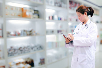 Doctor working in storage room at hospital 