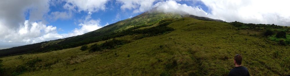 Low angle view of green landscape against sky