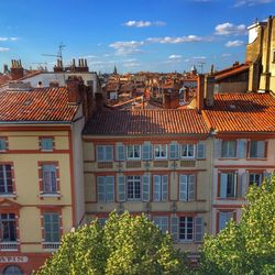 Residential buildings against blue sky