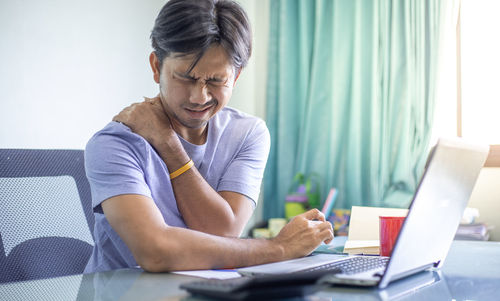 Man working on table at home