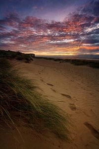 View of beach against cloudy sky