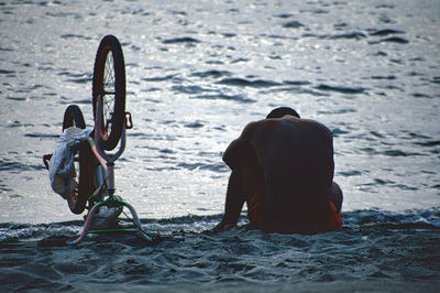 A man and his bicycle at the beach