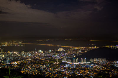 Illuminated cityscape against sky at night