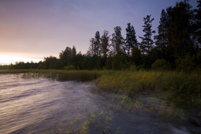 Scenic view of river against sky at sunset