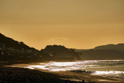 Scenic view of beach against sky during sunset