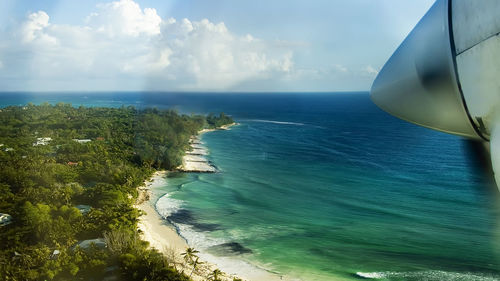 View from an approaching plane on one of the seychelles islands and blue, crystal clear sea water. 