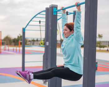 Rear view of woman exercising in gym