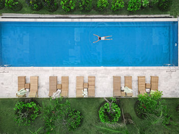 Aerial view of attractive woman floating over water at resort