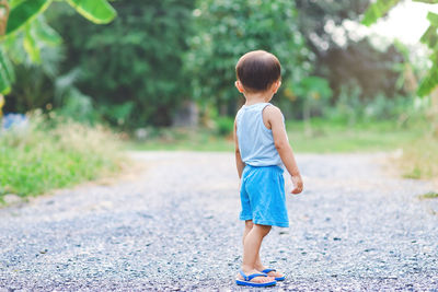 Rear view of boy walking outdoors