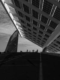 People walking on bridge in city