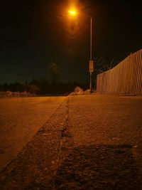 Illuminated farm against sky at night