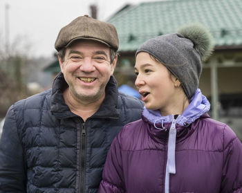 Portrait of happy man daughter during winter