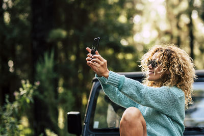 Midsection of woman using mobile phone