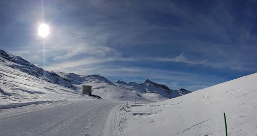 Scenic view of snow covered mountains against sky