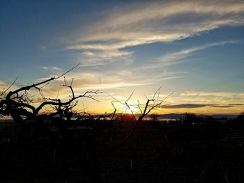 Scenic view of landscape against sky at sunset