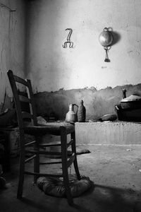 Empty chair against wall in old room