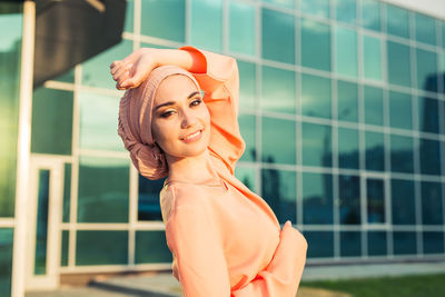 Portrait of a smiling young woman standing outdoors