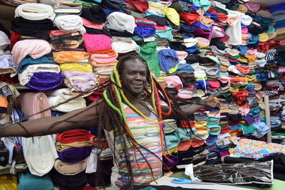 Portrait of man with dreadlocks standing at clothing store