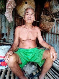 Portrait of smiling man sitting outdoors