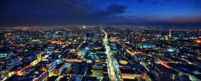 High angle view of city lit up at night