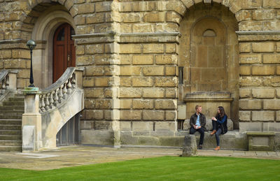 Low angle view of woman standing in old building