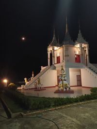 Illuminated building against sky at night