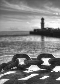 Close-up of chain against sea