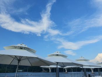 Gazebo by building against blue sky