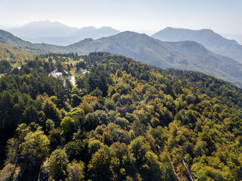 Scenic view of trees and mountains against sky