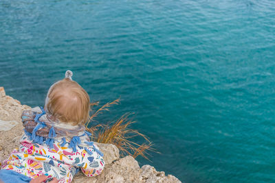 Rear view of girl looking at sea