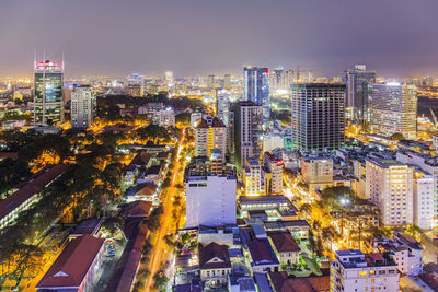 High angle view of illuminated cityscape against sky at night