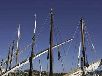 Low angle view of sailboat against blue sky