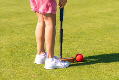 Low section of woman playing with ball