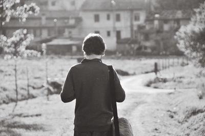 Rear view of woman standing against blurred background