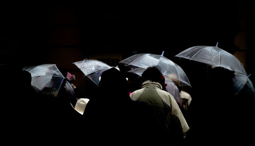 Rear view of people walking in the dark