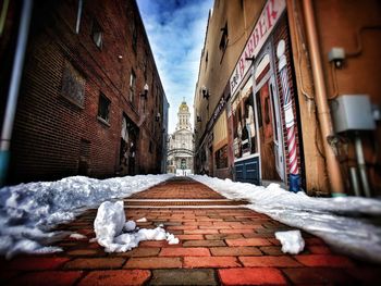 Snow covered street in city