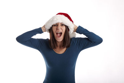 Portrait of young woman wearing hat against white background