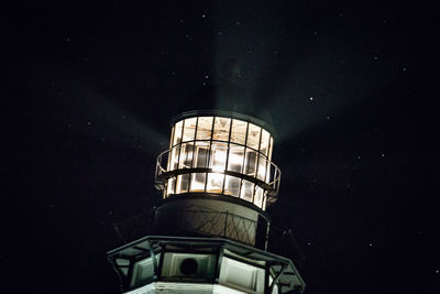 Low angle view of illuminated building against sky at night