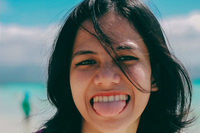 Close-up portrait of smiling young woman