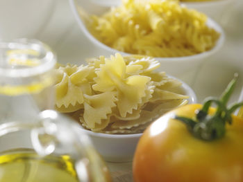 Close-up of pasta in bowls with tomato on table