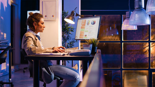 Young woman using laptop at cafe