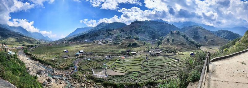 Panoramic view of agricultural field against sky