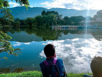 Rear view of woman by lake