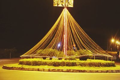 Illuminated ferris wheel at night