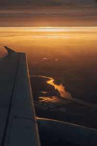 Aerial view of sea against sky during sunset