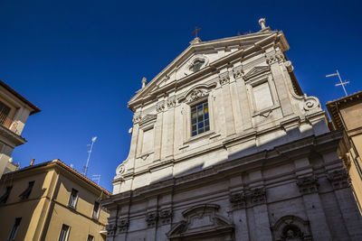 Low angle view of building against clear blue sky