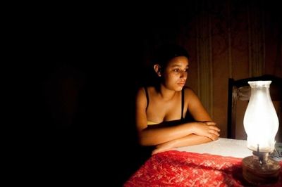Portrait of young woman sitting on bench