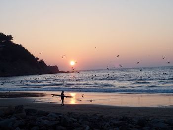 Scenic view of beach against sky during sunset