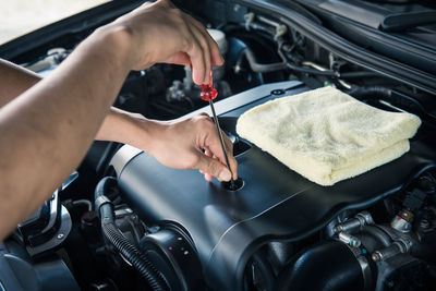 Auto mechanic checking car engine,worker selective focus